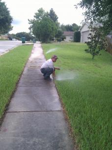 Sprinkler repair technician recalibrates a system