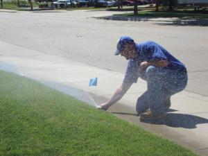 Irrigation Contractor checks a pop up head